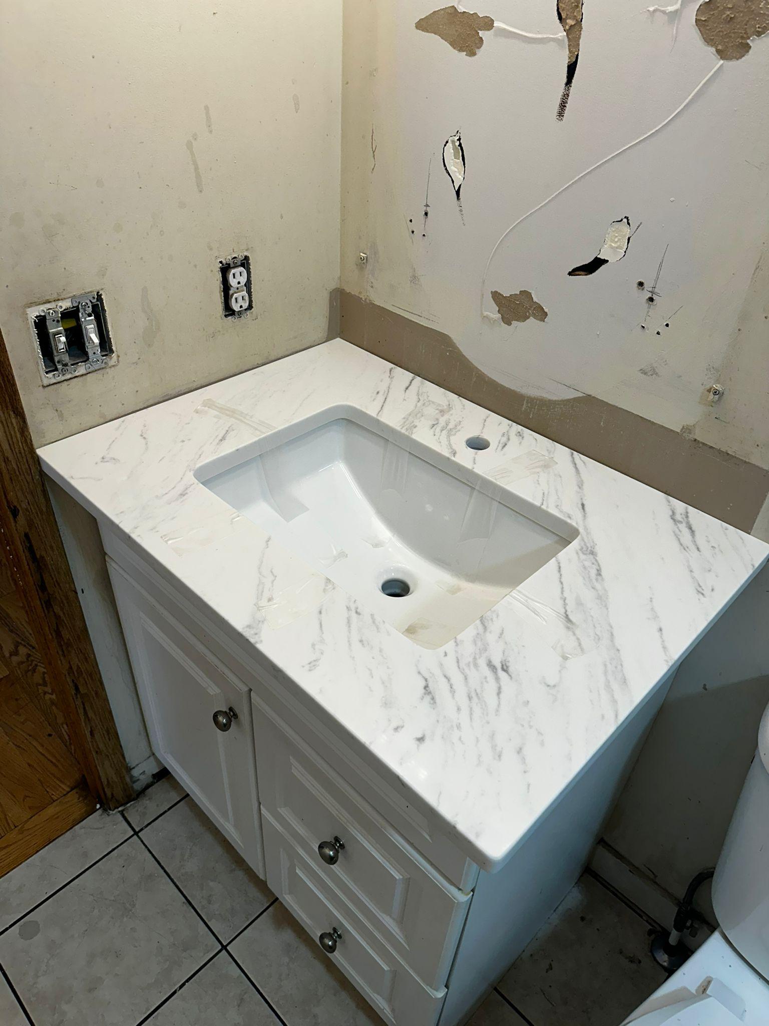 White quartz bathroom vanity top with undermount sink installed in Calgary