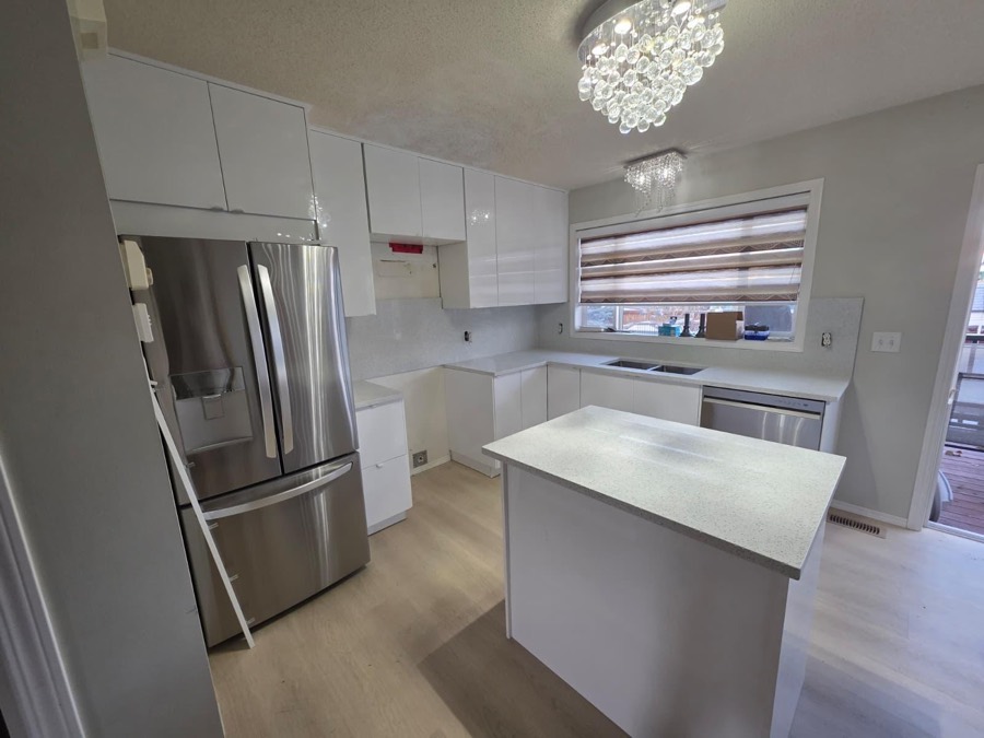 Light speckled quartz island, Calgary install by Bedrock Countertops