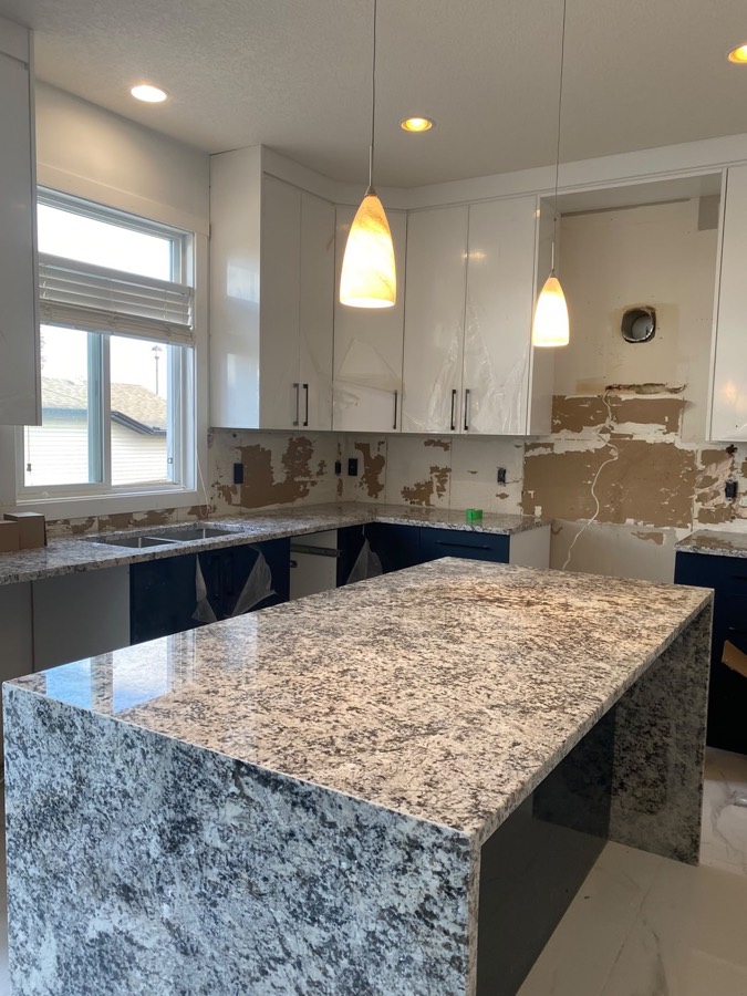 Granite waterfall island, Calgary install by Bedrock Countertops